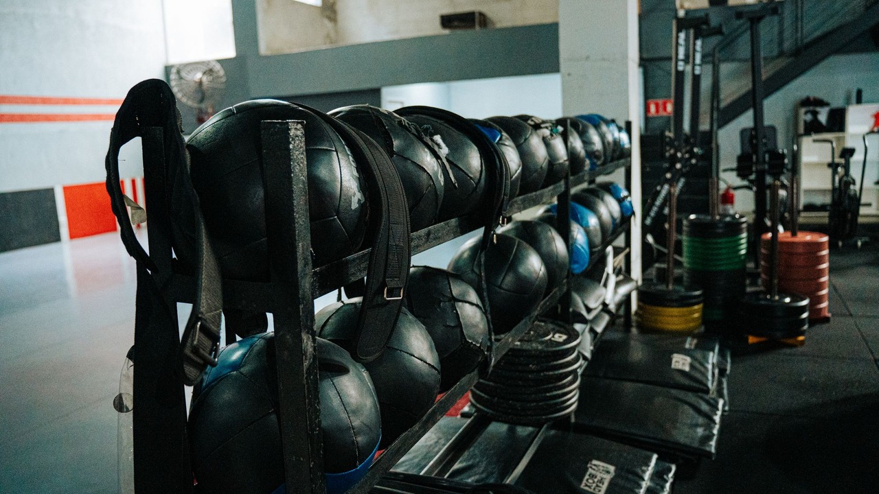 Weights and exercise equipment arranged in a gym.