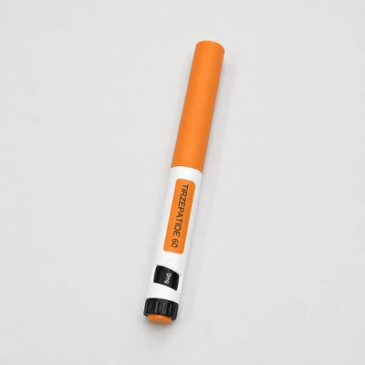 Peptides in Bali TIRZEPATIDE 60 pen resting on a light neutral studio surface.