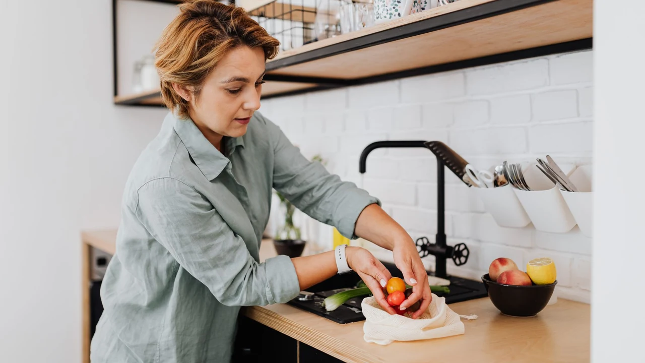 An adult preparing vegetables at a kitchen counter