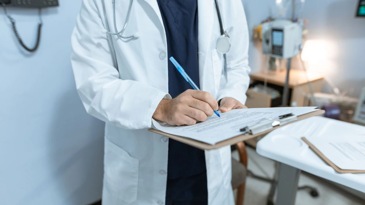 Clinician making notes on a clipboard