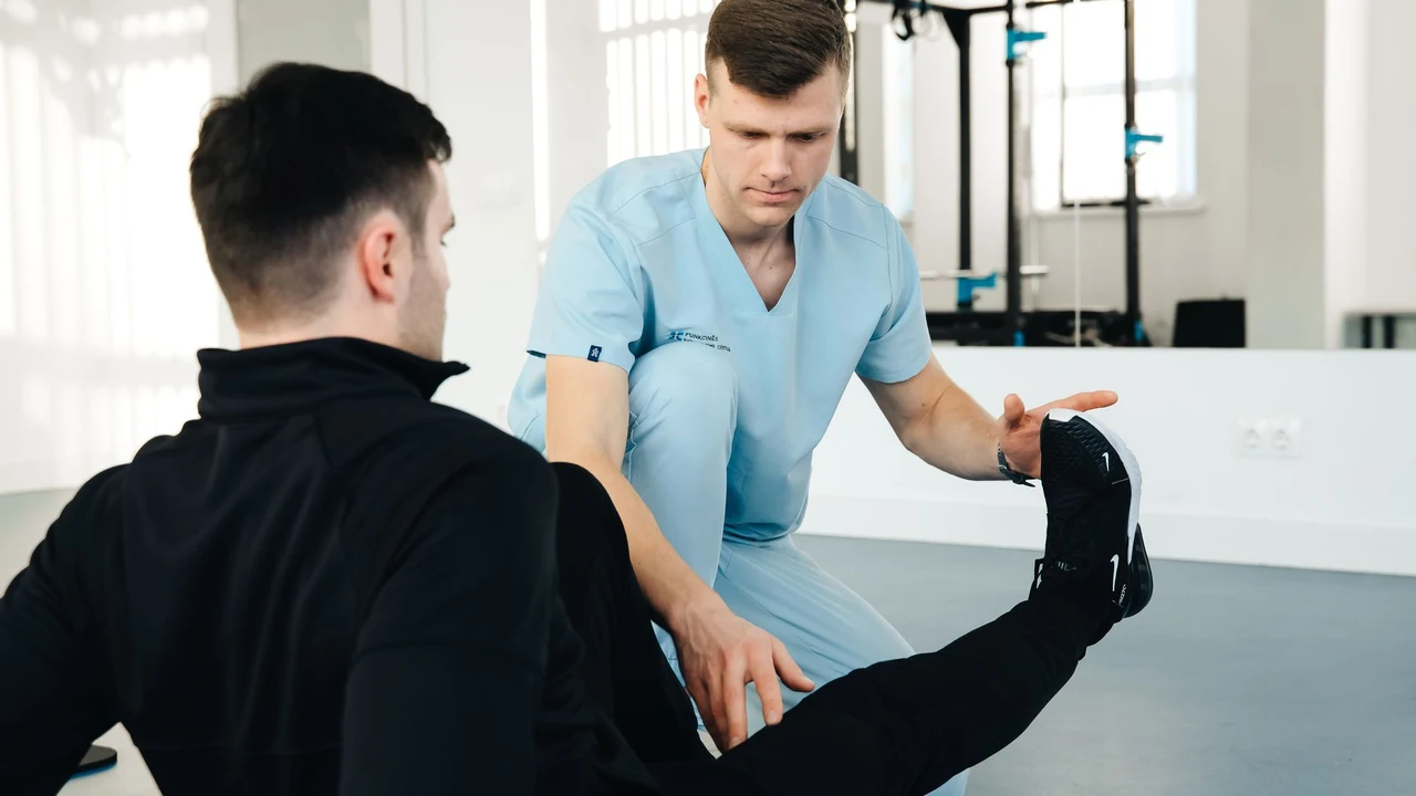 Physiotherapist supporting a seated person's leg