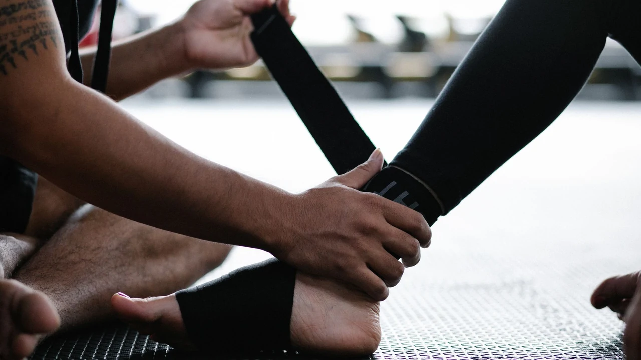 Hands assisting an ankle movement during an exercise session