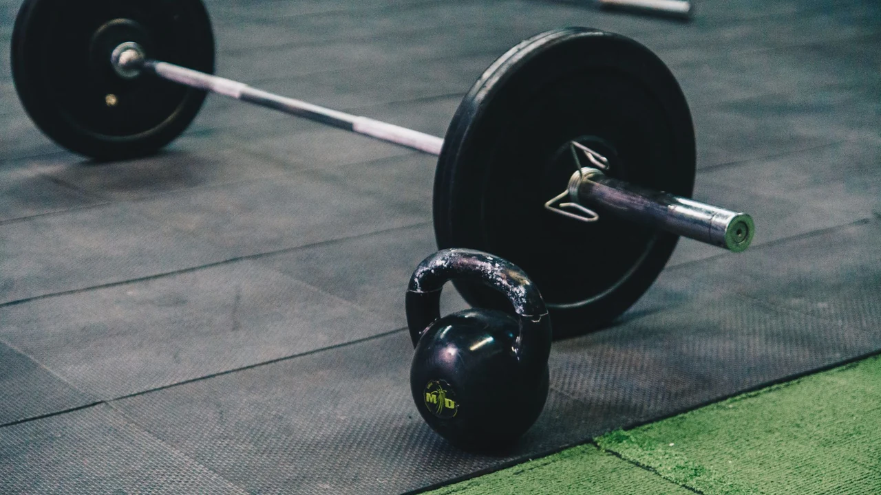 Barbell and kettlebell on a gym floor