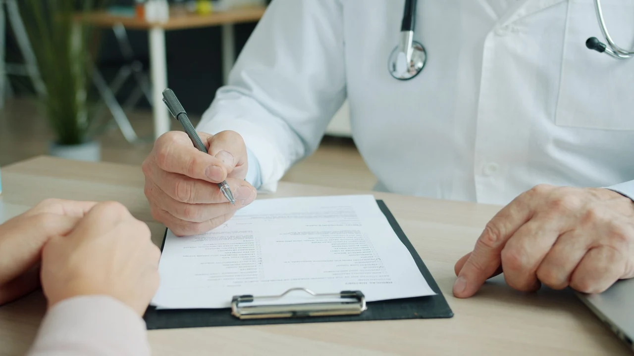Clinician writing on a clipboard
