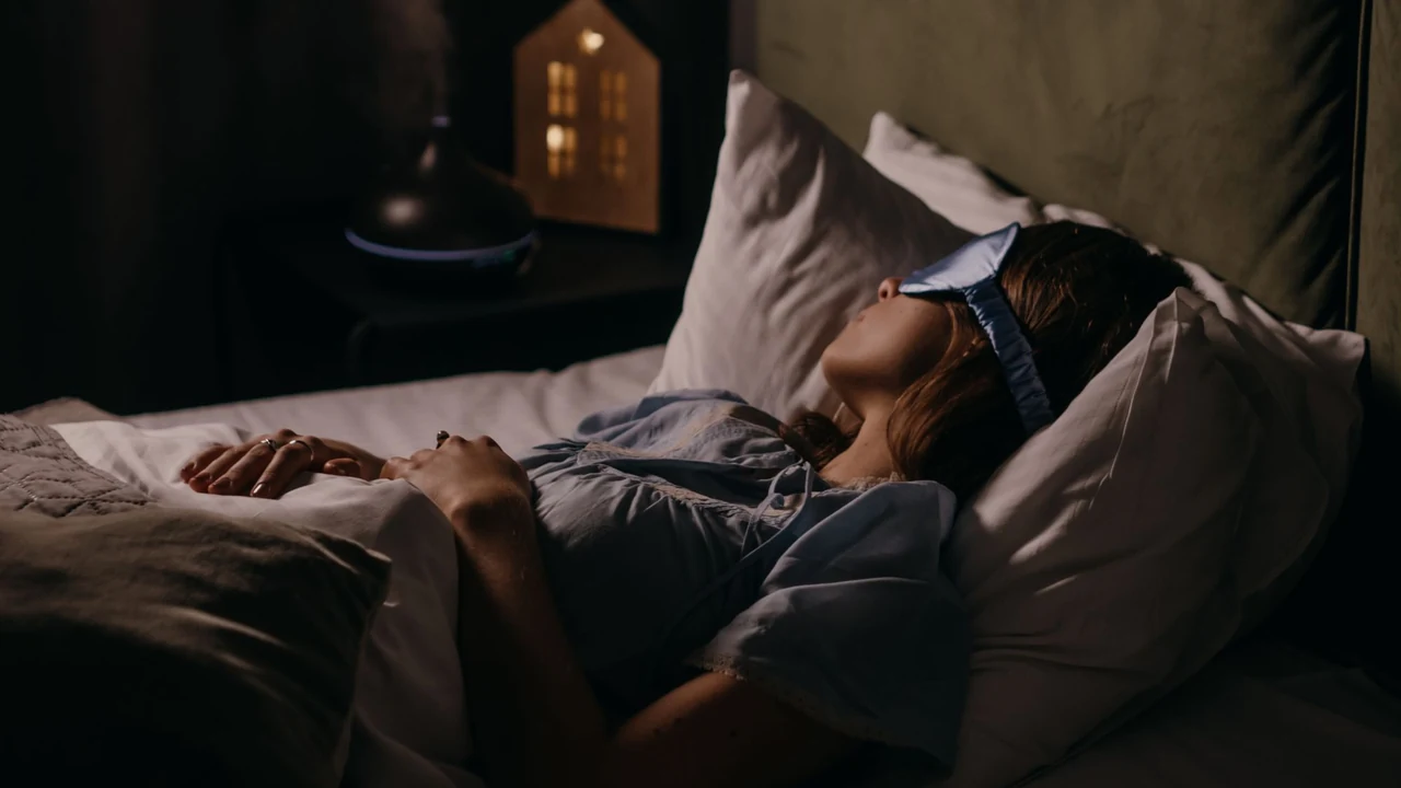 Person resting in bed wearing an eye mask
