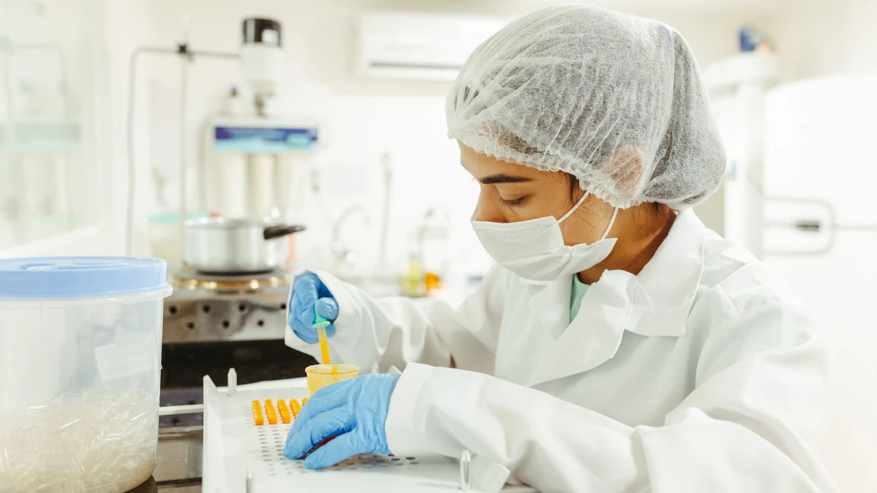 Gloved laboratory worker handling sample tubes