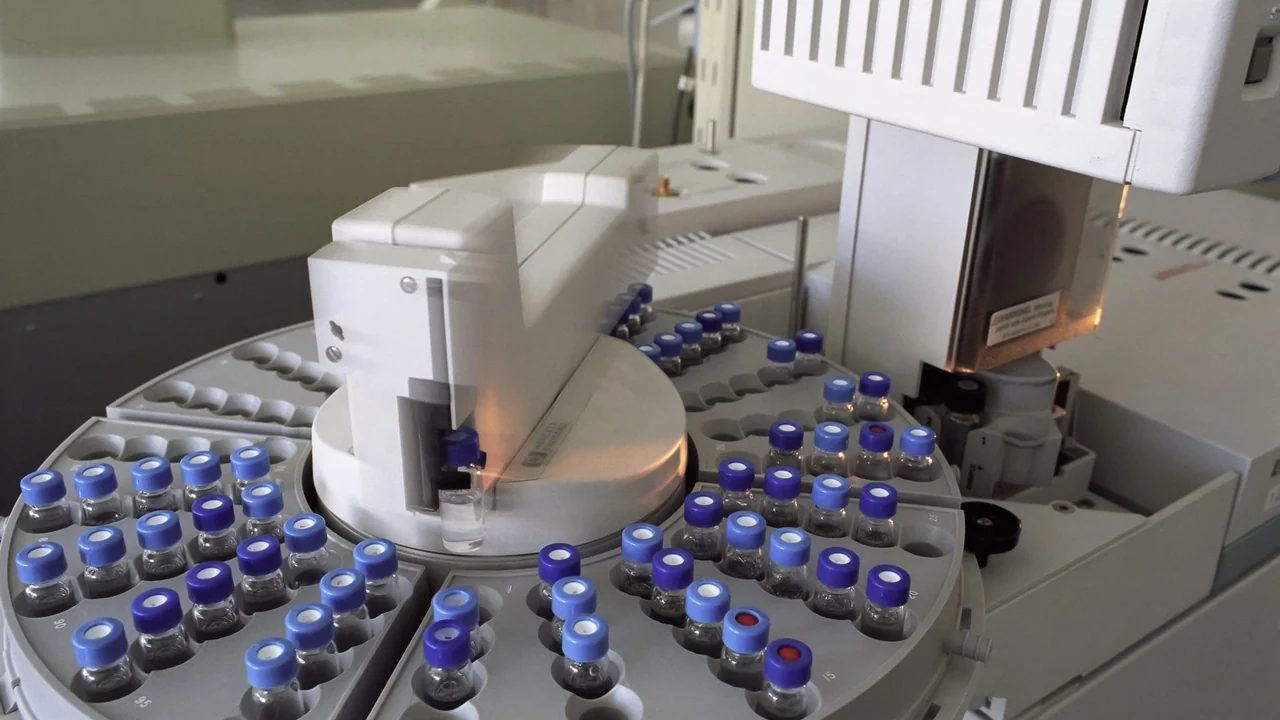 Labelled sample vials arranged in laboratory equipment.
