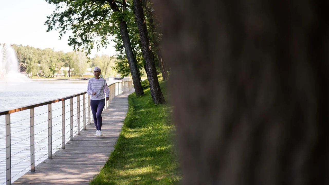 A person walking beside the water.
