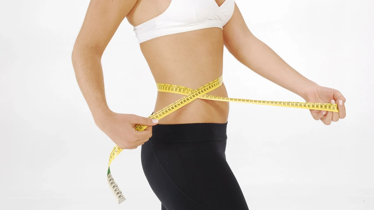 Measuring tape positioned around a waist.