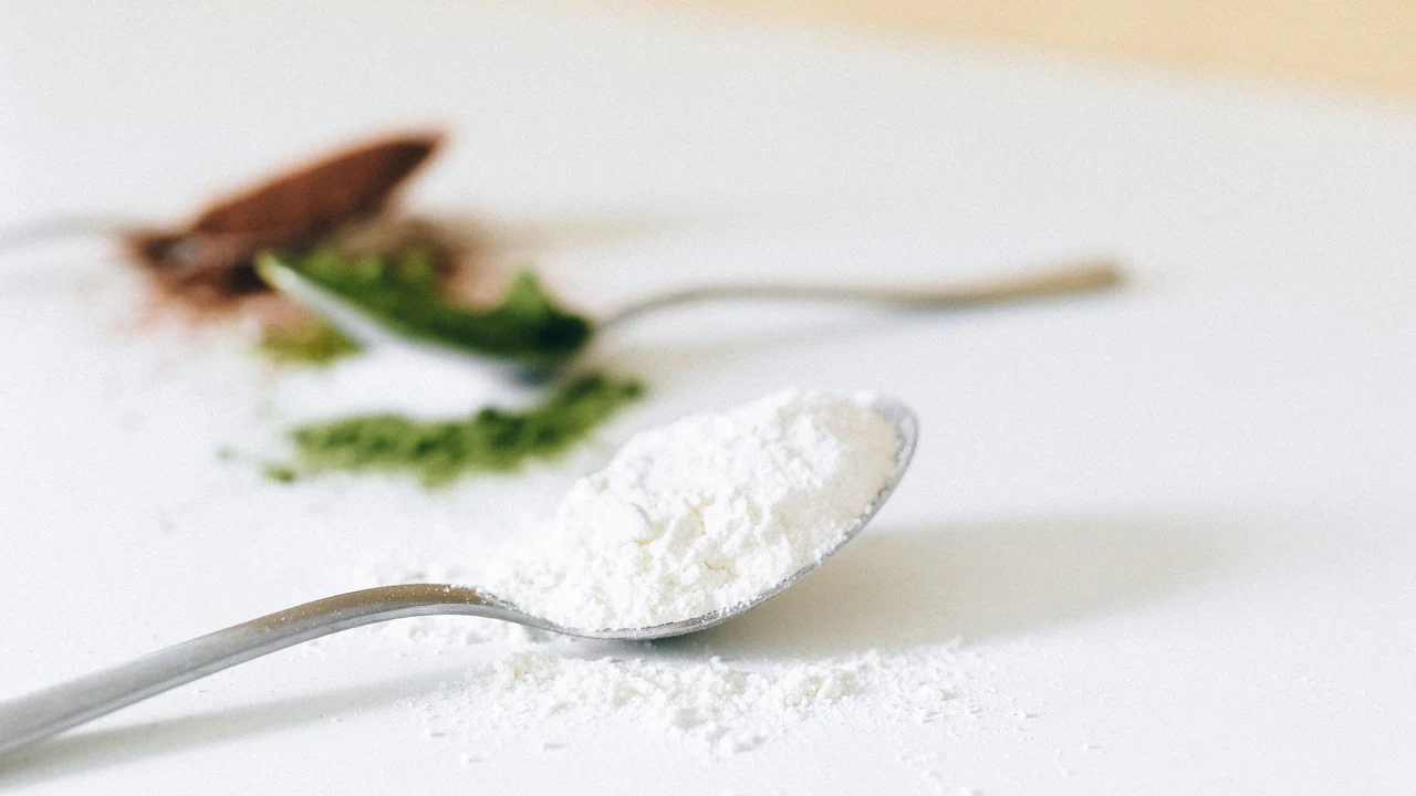 Unlabelled white powder on a spoon beside other powders