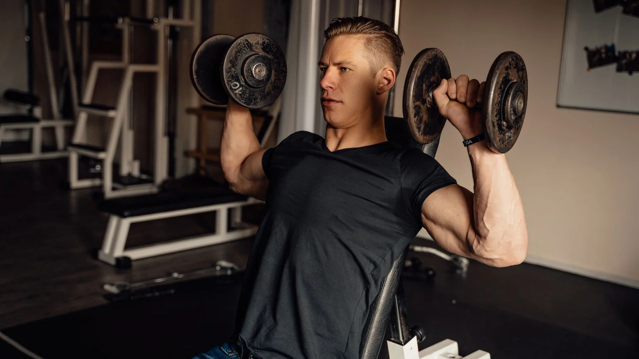 Man performing a dumbbell shoulder press