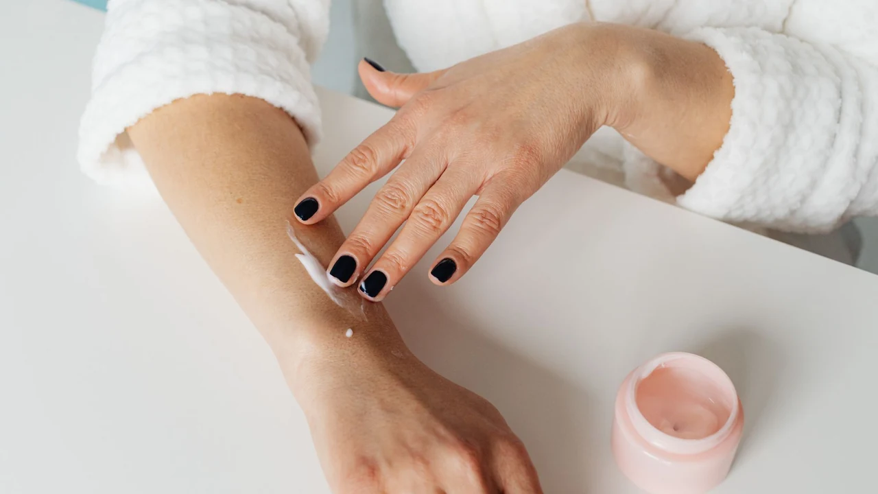 Small amount of cream being applied to an arm