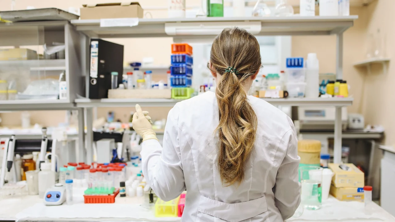 Person in a laboratory coat working at a lab bench