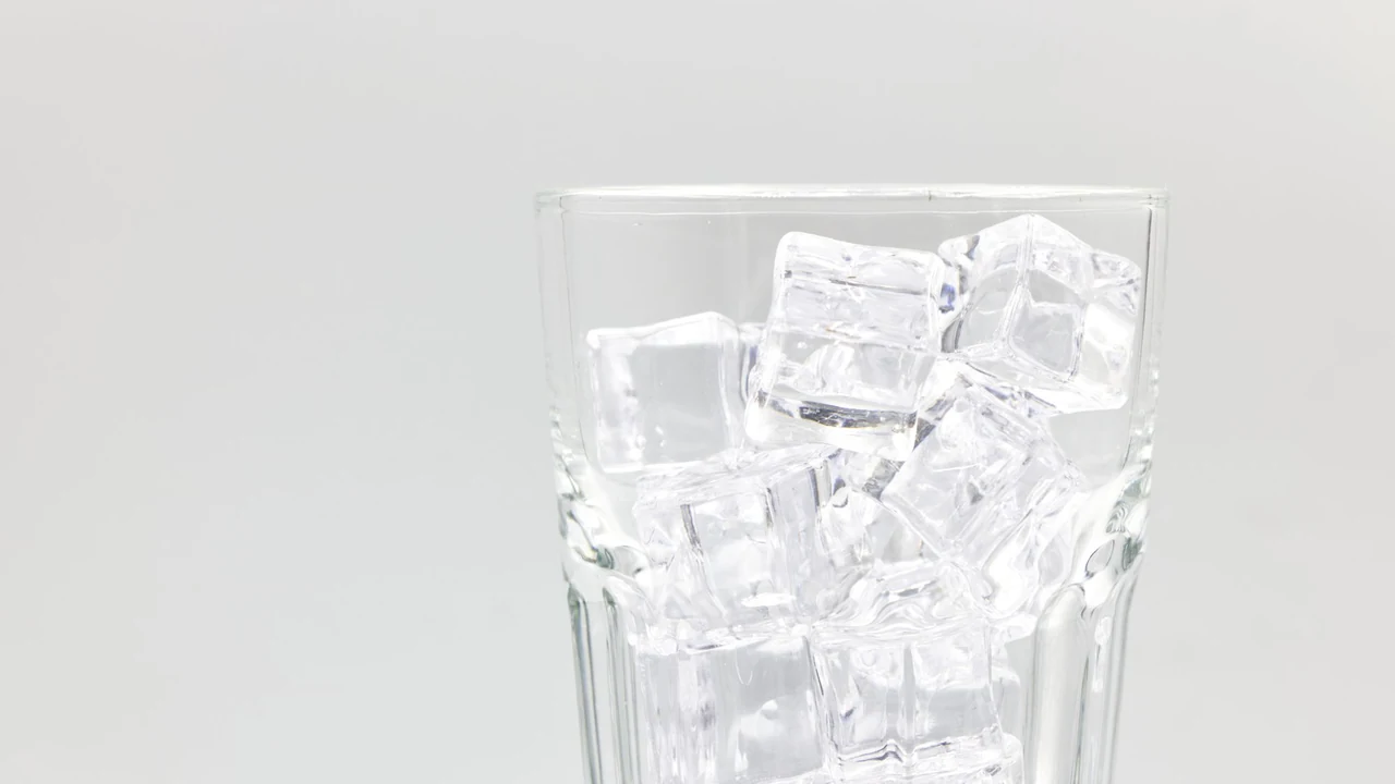 Clear ice cubes in a glass.