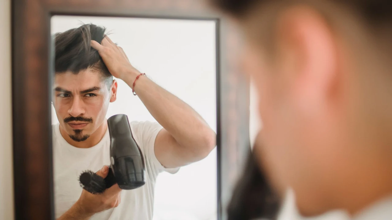 Man styling his hair in front of a mirror.
