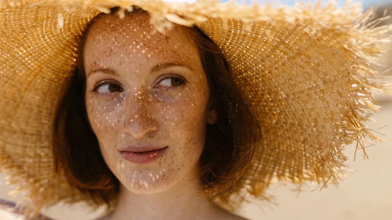 Woman wearing a wide-brimmed straw hat.