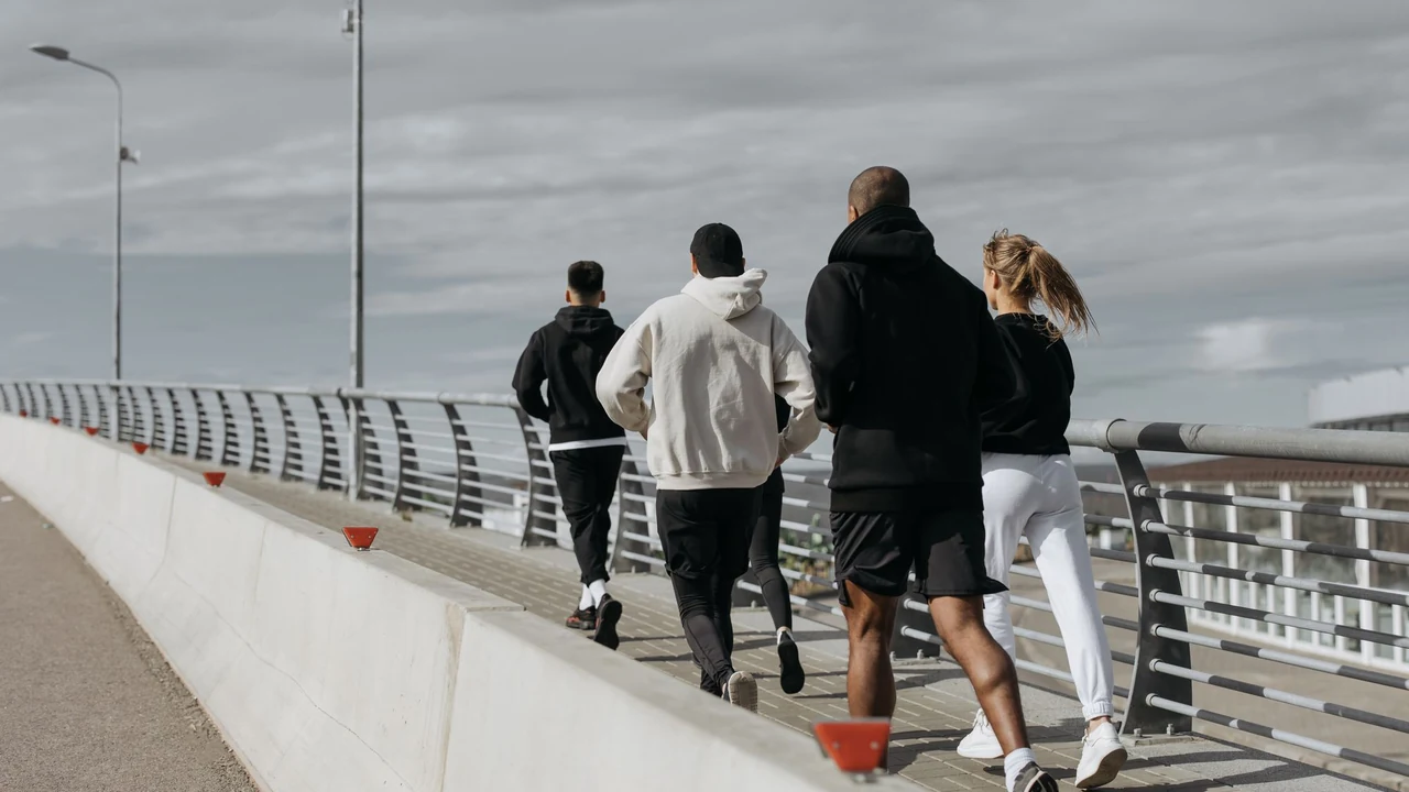 Runners beside a waterfront.