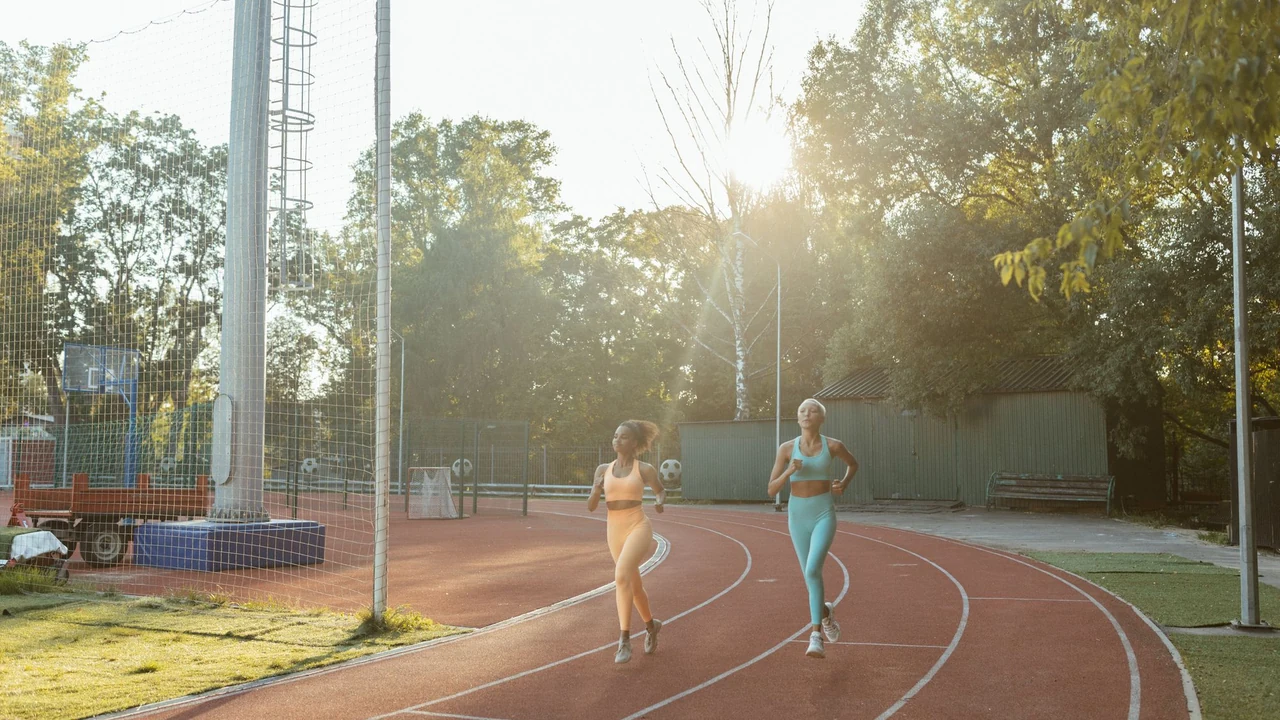 Two people running on an outdoor track.
