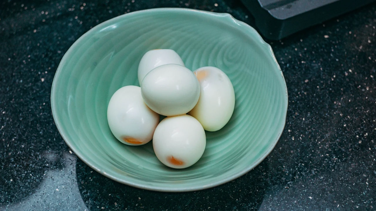 Peeled hard-boiled eggs on a plate.