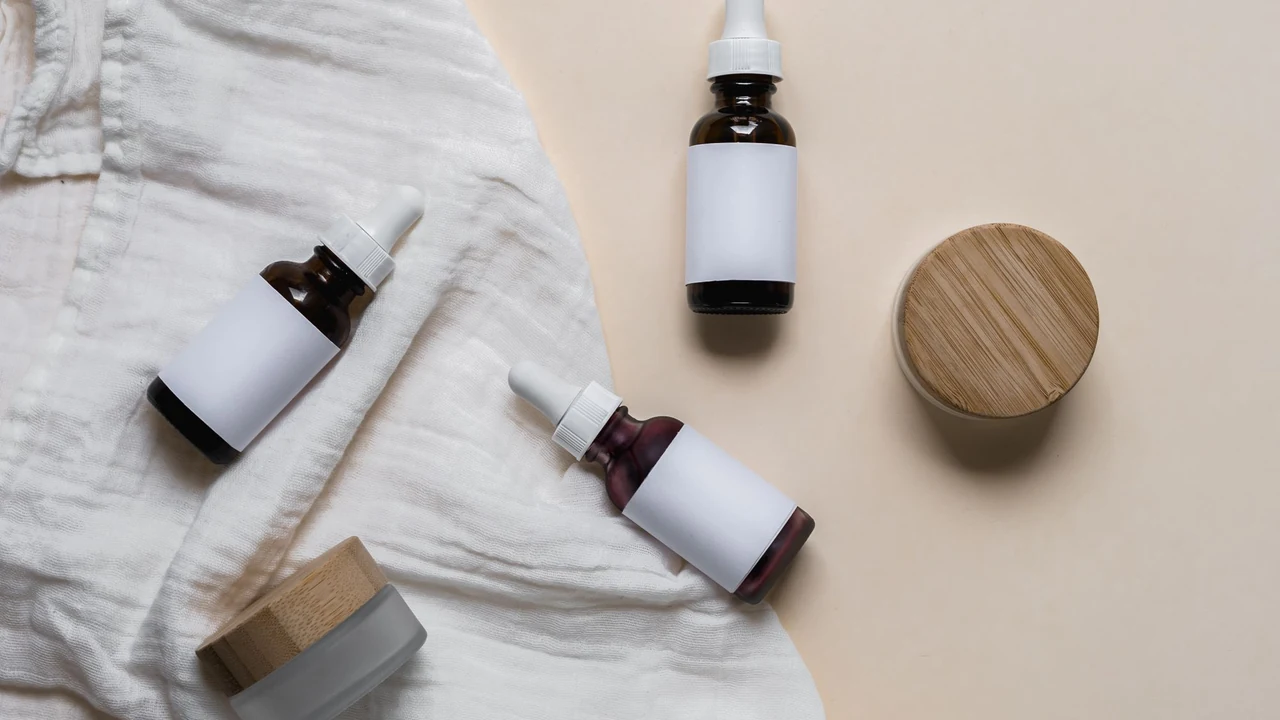 Dropper bottles and cream jars on a cloth.