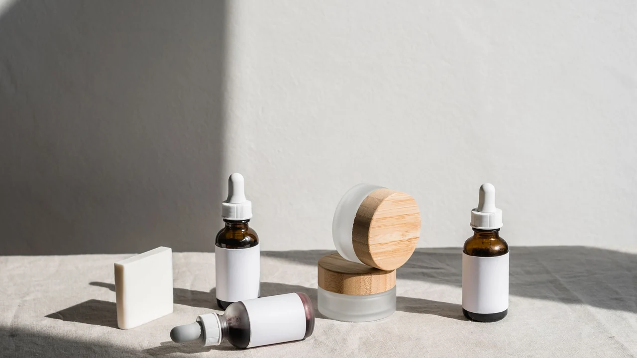 Unlabelled skincare bottles and jars on a light surface