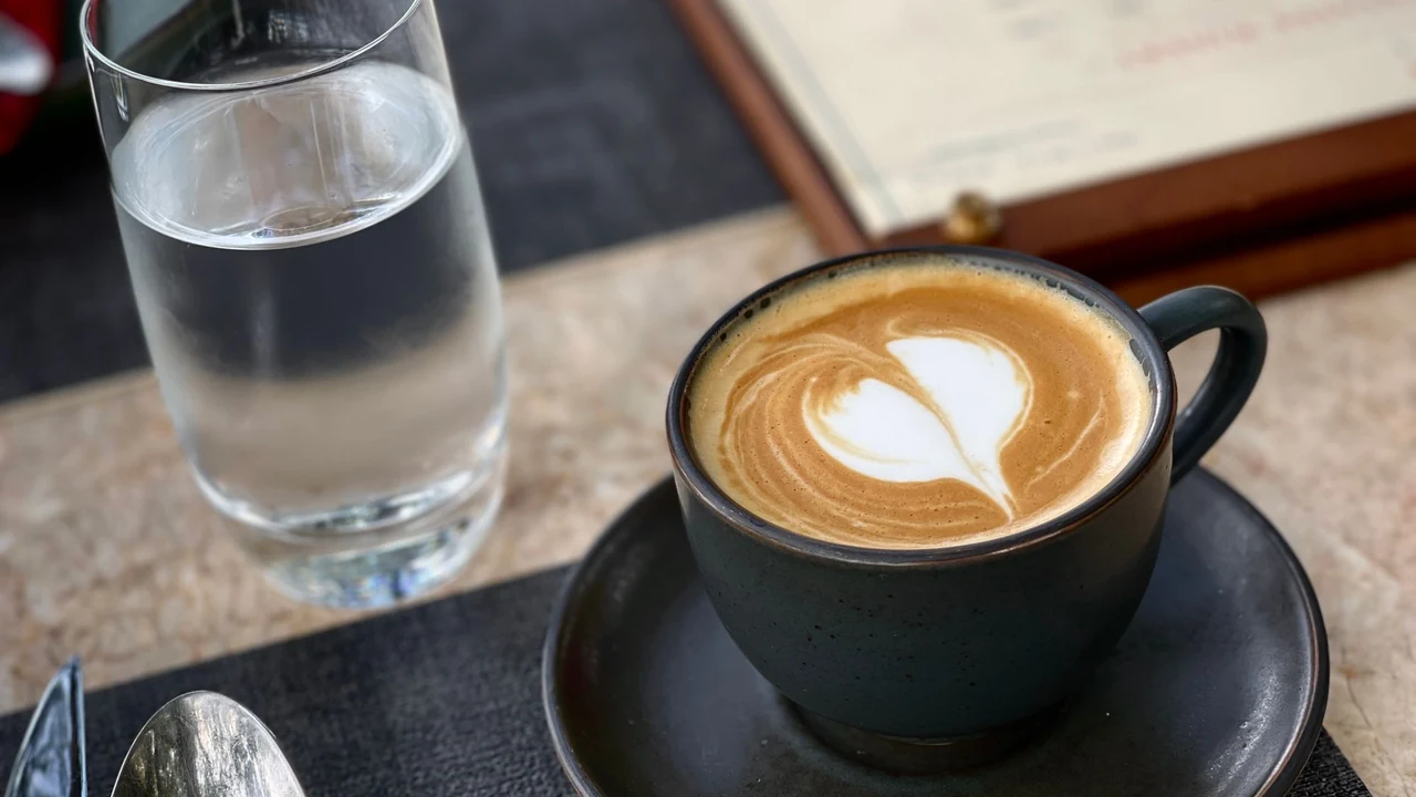 A cup of coffee beside a glass of water