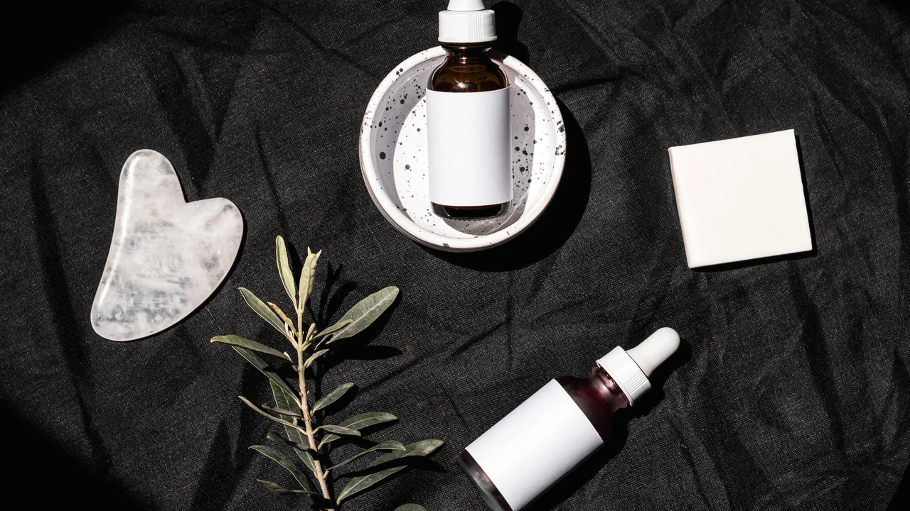 Skincare bottles with blank labels on a dark surface
